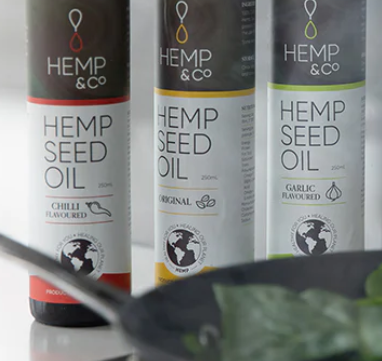 Using hemp seed oil to cook spinach in a fry pan.
