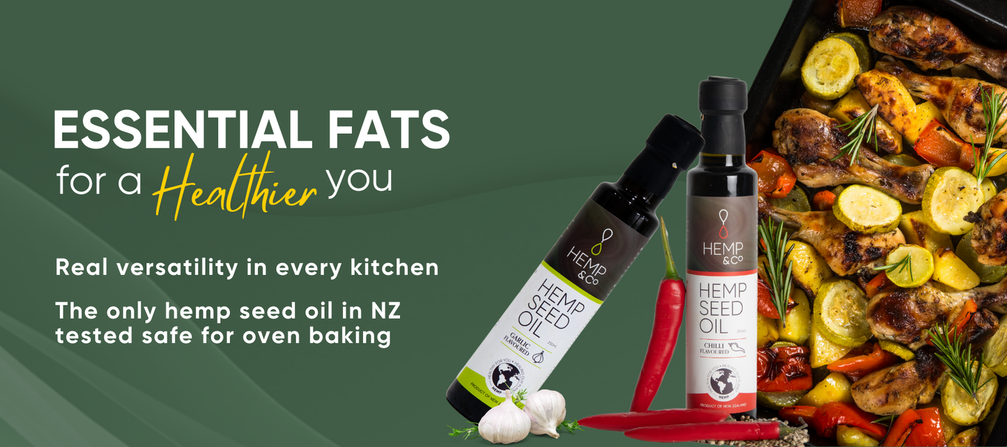 Hemp seed oil bottles with roasted vegetables on a green background