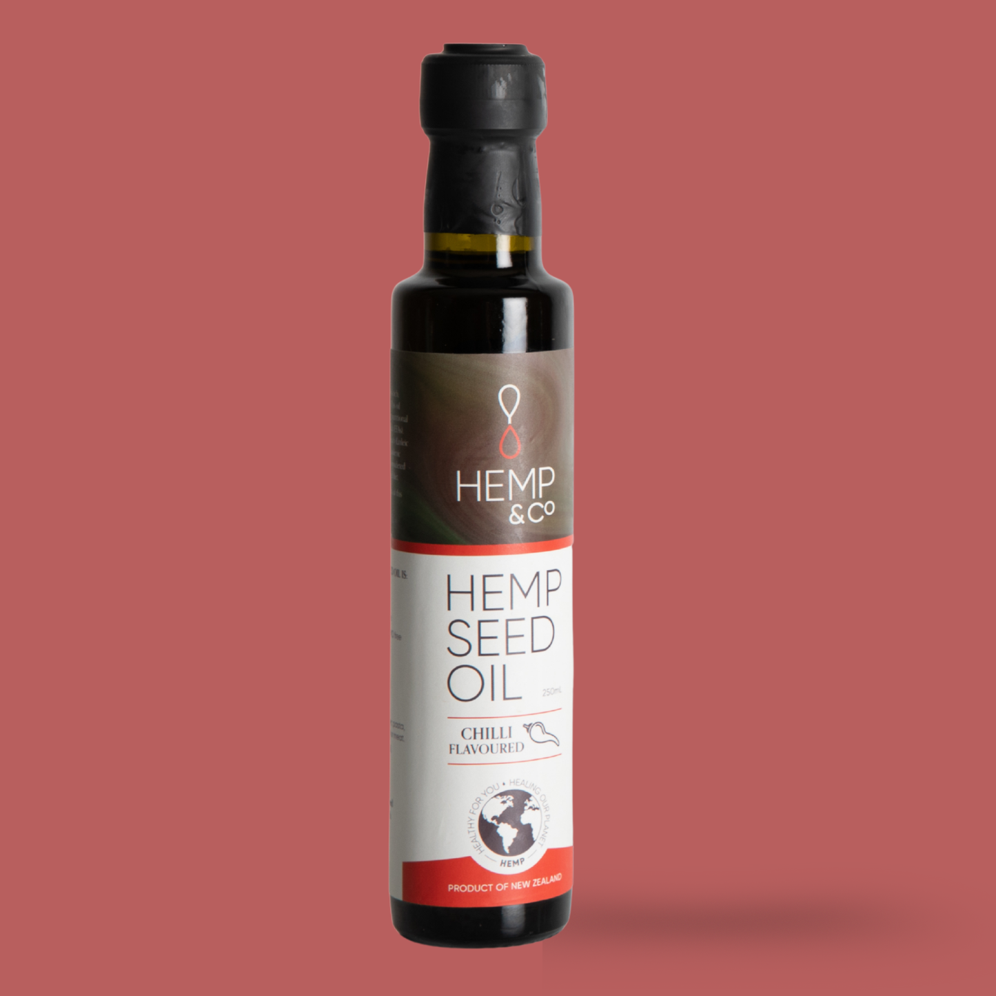 Bottle of Hemp & Co. Chilli Flavoured Hemp Seed Oil on a red background