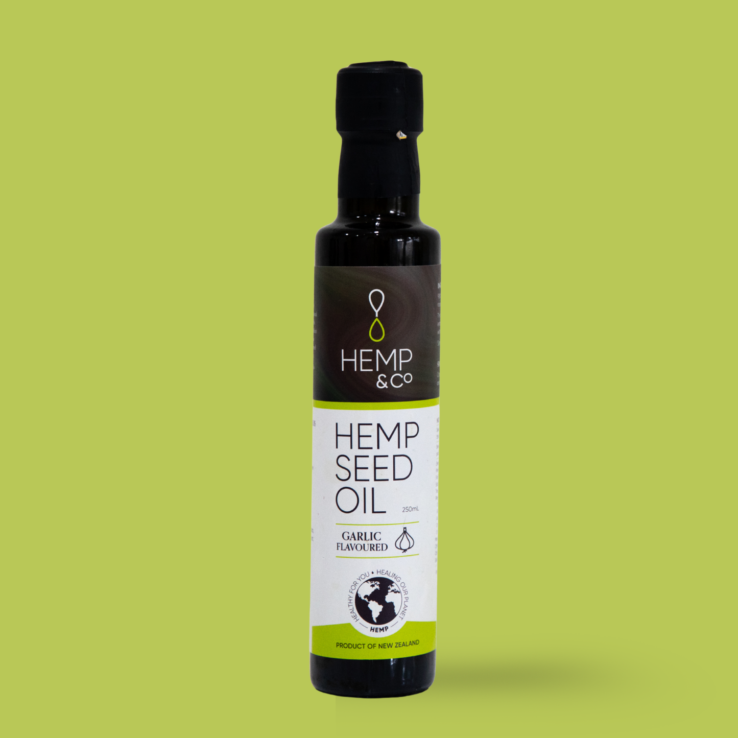Bottle of Hemp & Co hemp seed oil on a green background