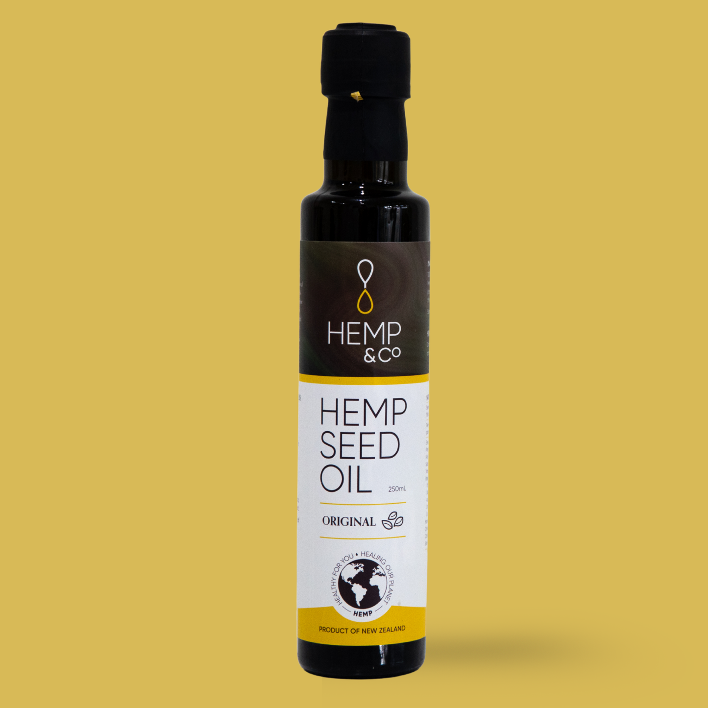 Bottle of Hemp & Co hemp seed oil on a yellow background