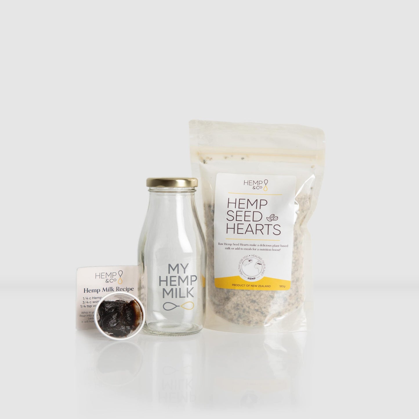 Hemp milk starter pack with hemp hearts, bottle, date paste concentrate, and fridge magnet
